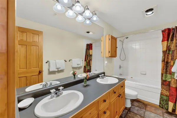 a bathroom with a double vanity sink mirror and double