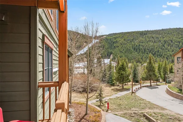 a living room with furniture potted plant and a table