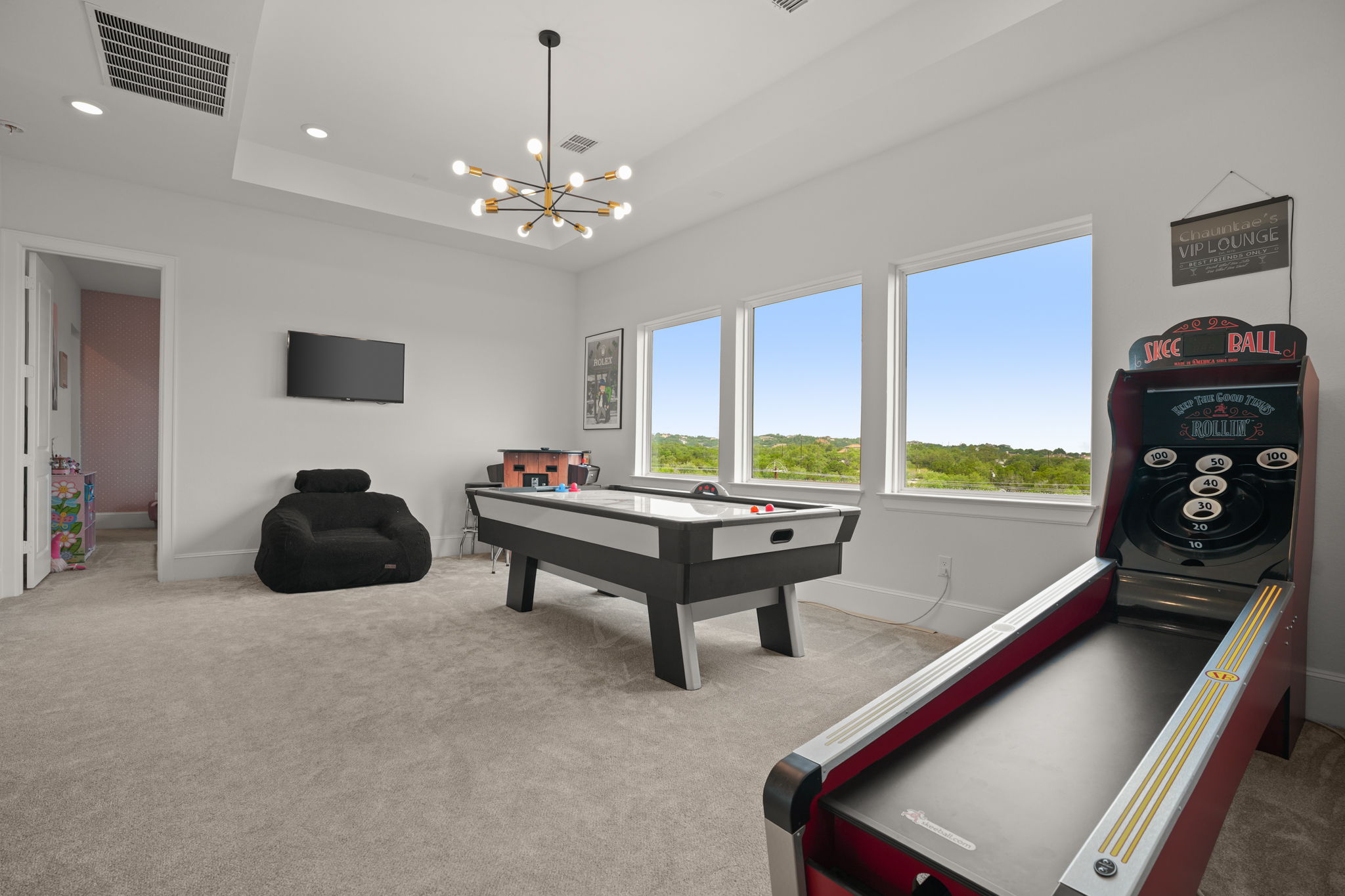 104 Lodestone Cove Austin, TX 78738 - Photo 25 of 40 A well-lit game room features generous windows offering views of the surrounding landscape.