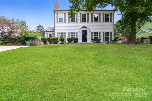 a front view of house with yard and green space