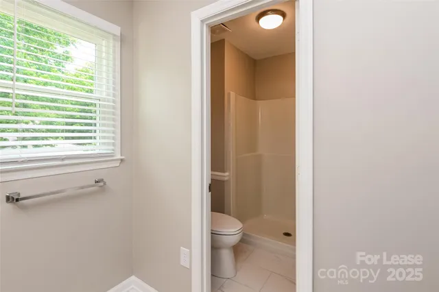 a bathroom with a toilet sink and a window