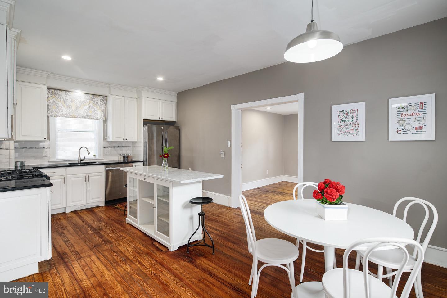 123 Potter Street Haddonfield, NJ 08033 - Photo 11 of 31 a kitchen with stainless steel appliances granite countertop a kitchen island hardwood floor sink stove dining table and chairs