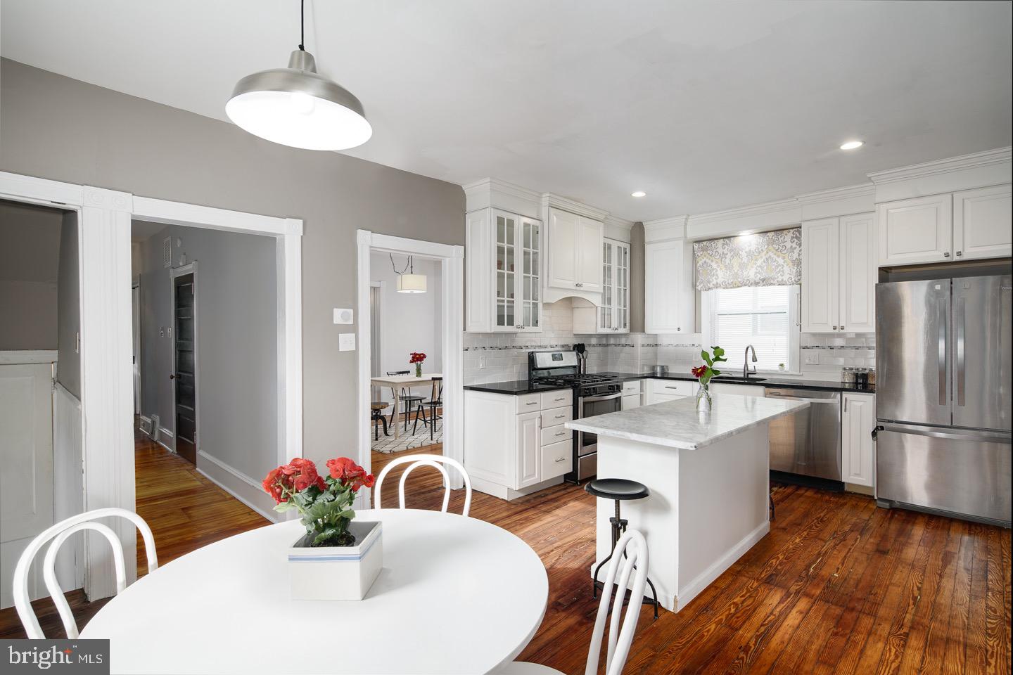 123 Potter Street Haddonfield, NJ 08033 - Photo 12 of 31 a kitchen with stainless steel appliances a dining table chairs a refrigerator and cabinets