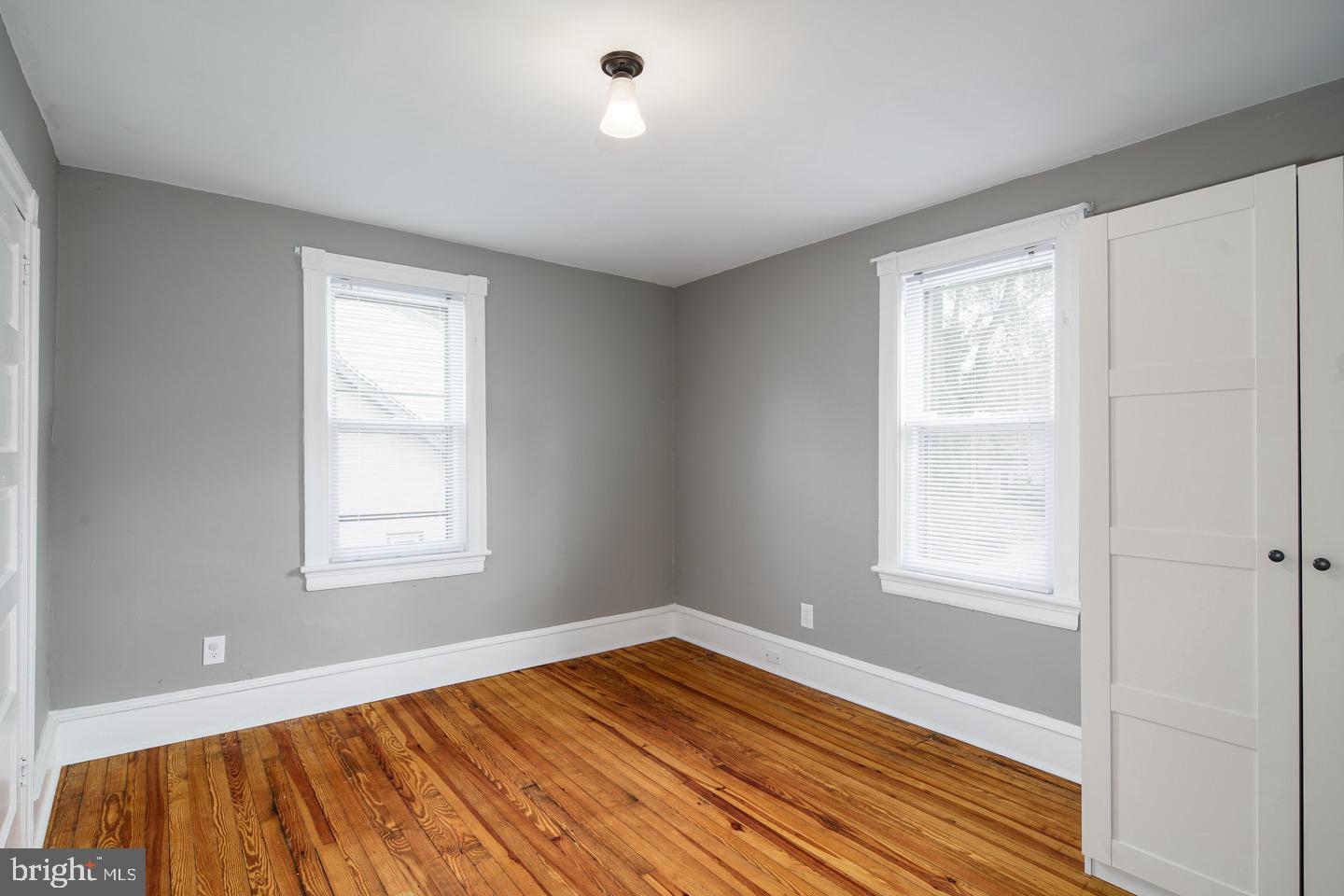 123 Potter Street Haddonfield, NJ 08033 - Photo 19 of 31 a view of an empty room with wooden floor and a window