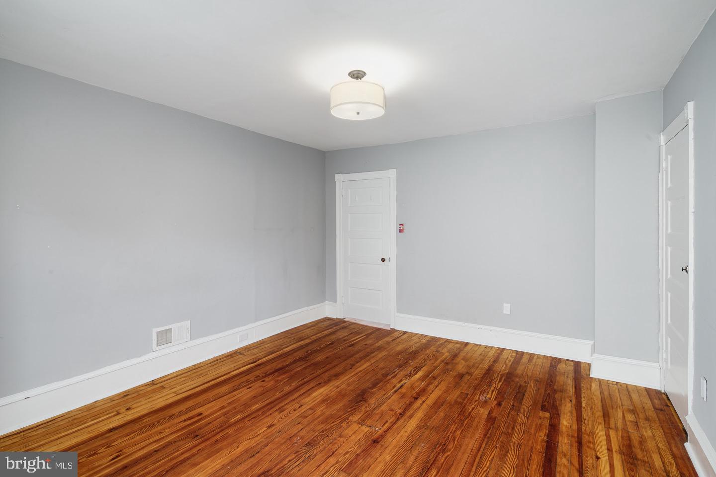 123 Potter Street Haddonfield, NJ 08033 - Photo 22 of 31 a view of an empty room with wooden floor and a window