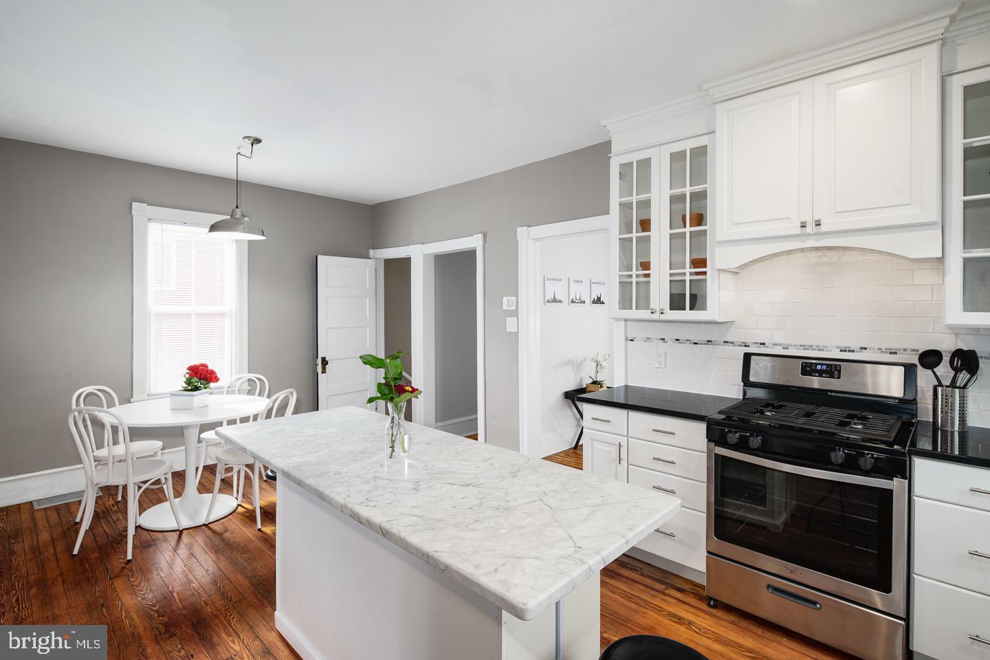 123 Potter Street Haddonfield, NJ 08033 - Photo 7 of 31 a kitchen with stainless steel appliances a stove a sink dishwasher and white cabinets with wooden floor