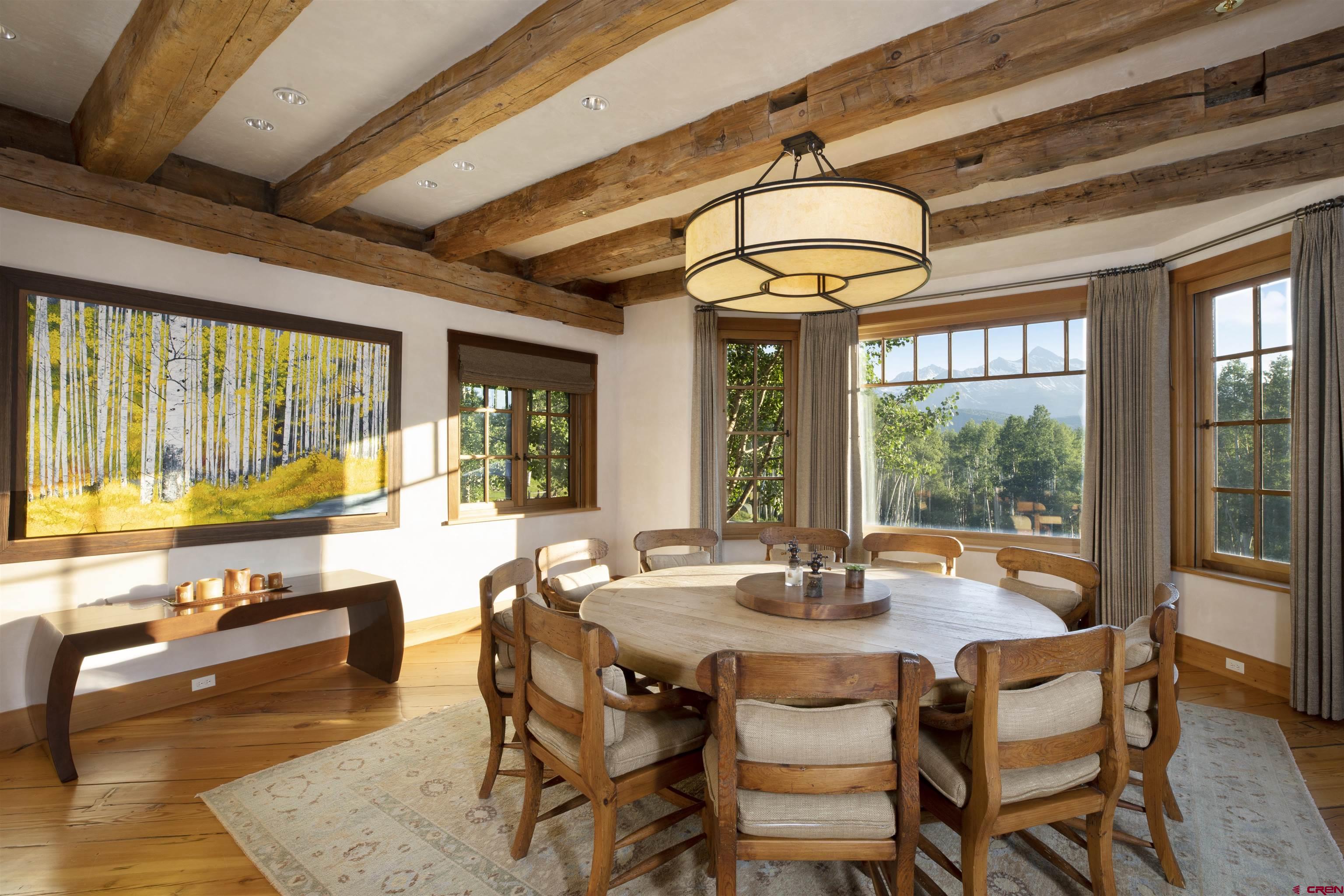 8121 Preserve Drive Telluride, CO 81435 - Photo 11 of 35 a dining room with wooden floor and large windows