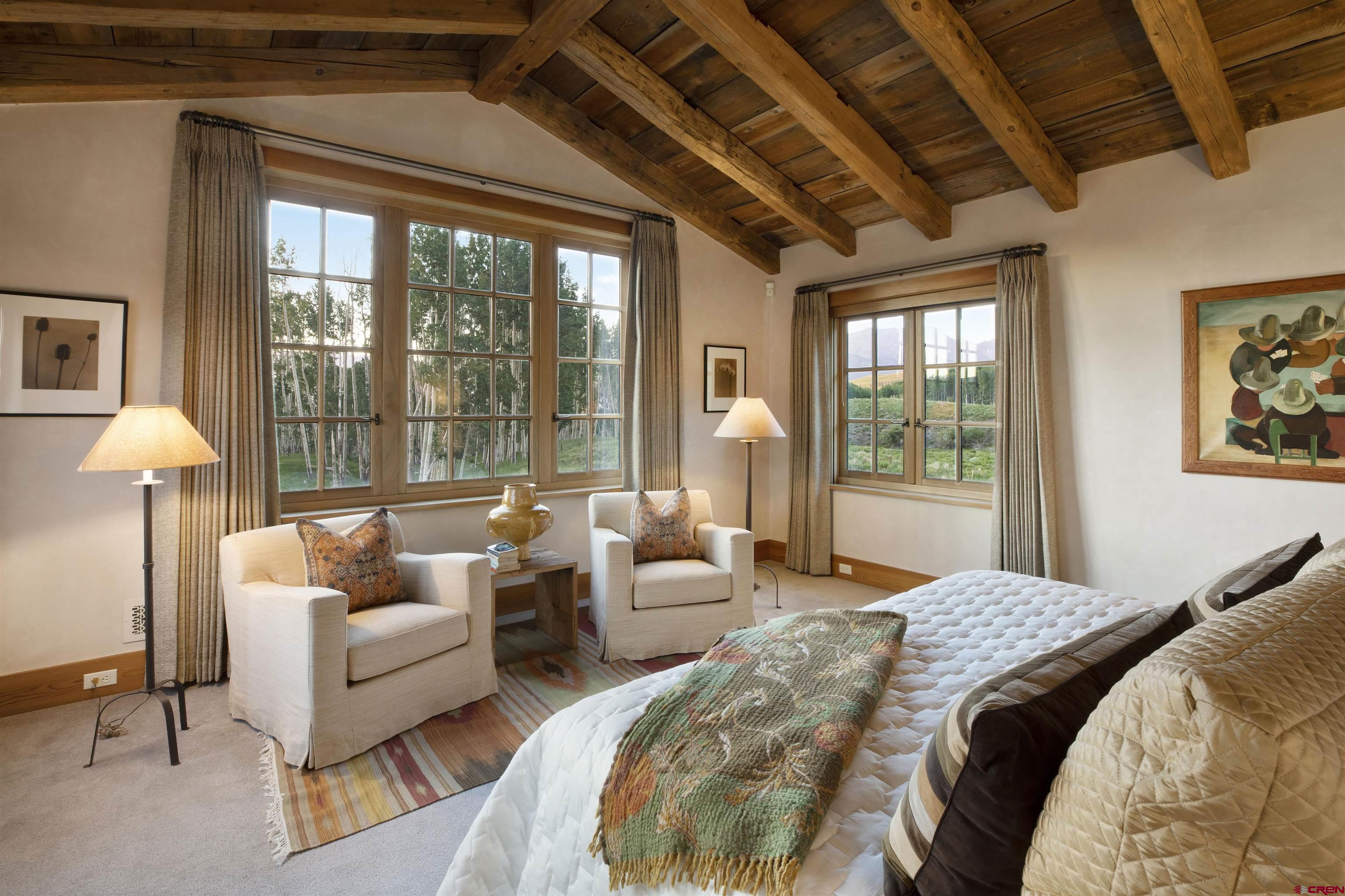 8121 Preserve Drive Telluride, CO 81435 - Photo 18 of 35 a spacious bedroom with a bed and glass window