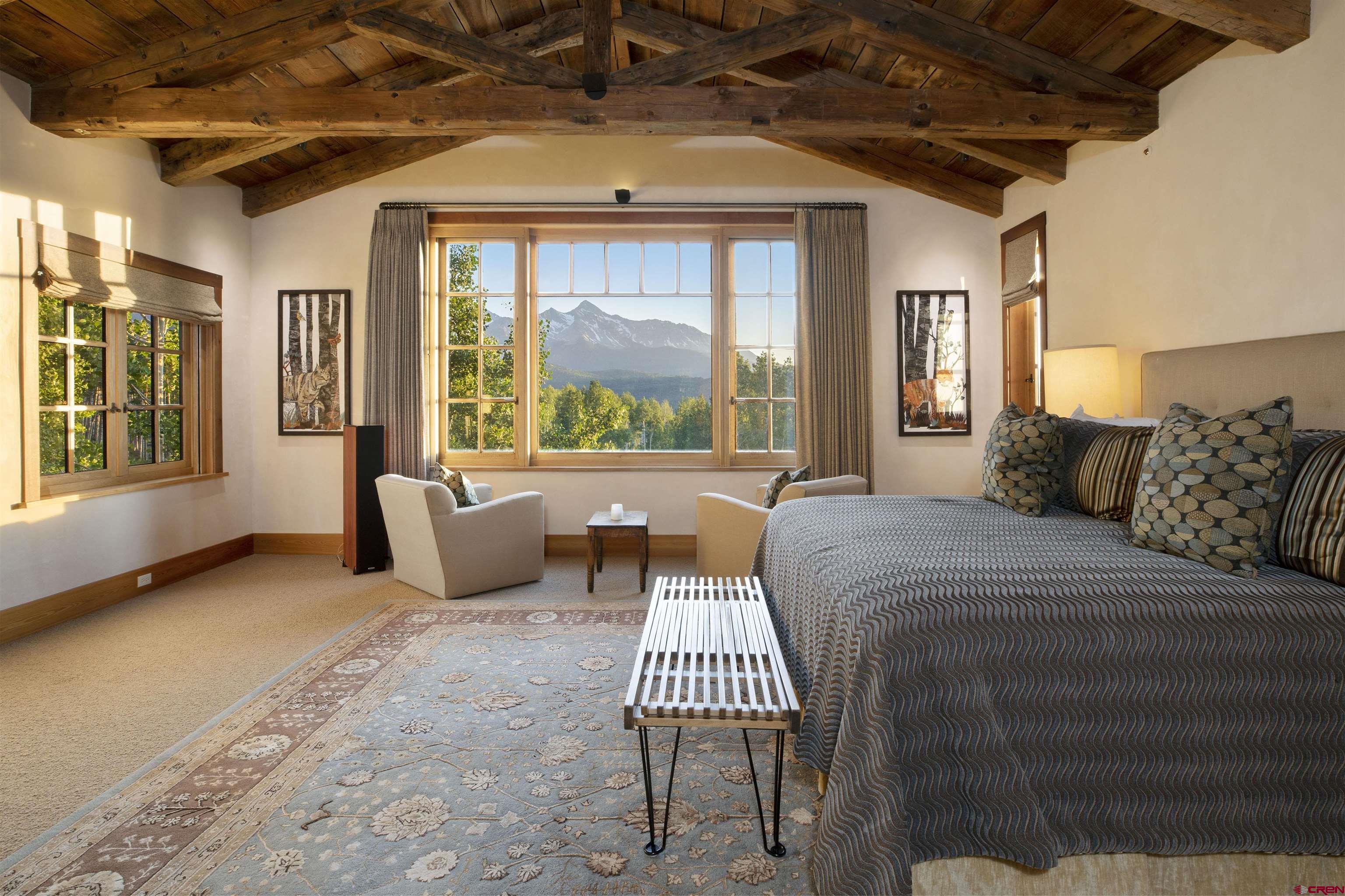 8121 Preserve Drive Telluride, CO 81435 - Photo 22 of 35 a spacious bedroom with a balcony a bed and a couch