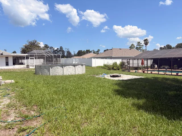 a view of a big house with a big yard and potted plants
