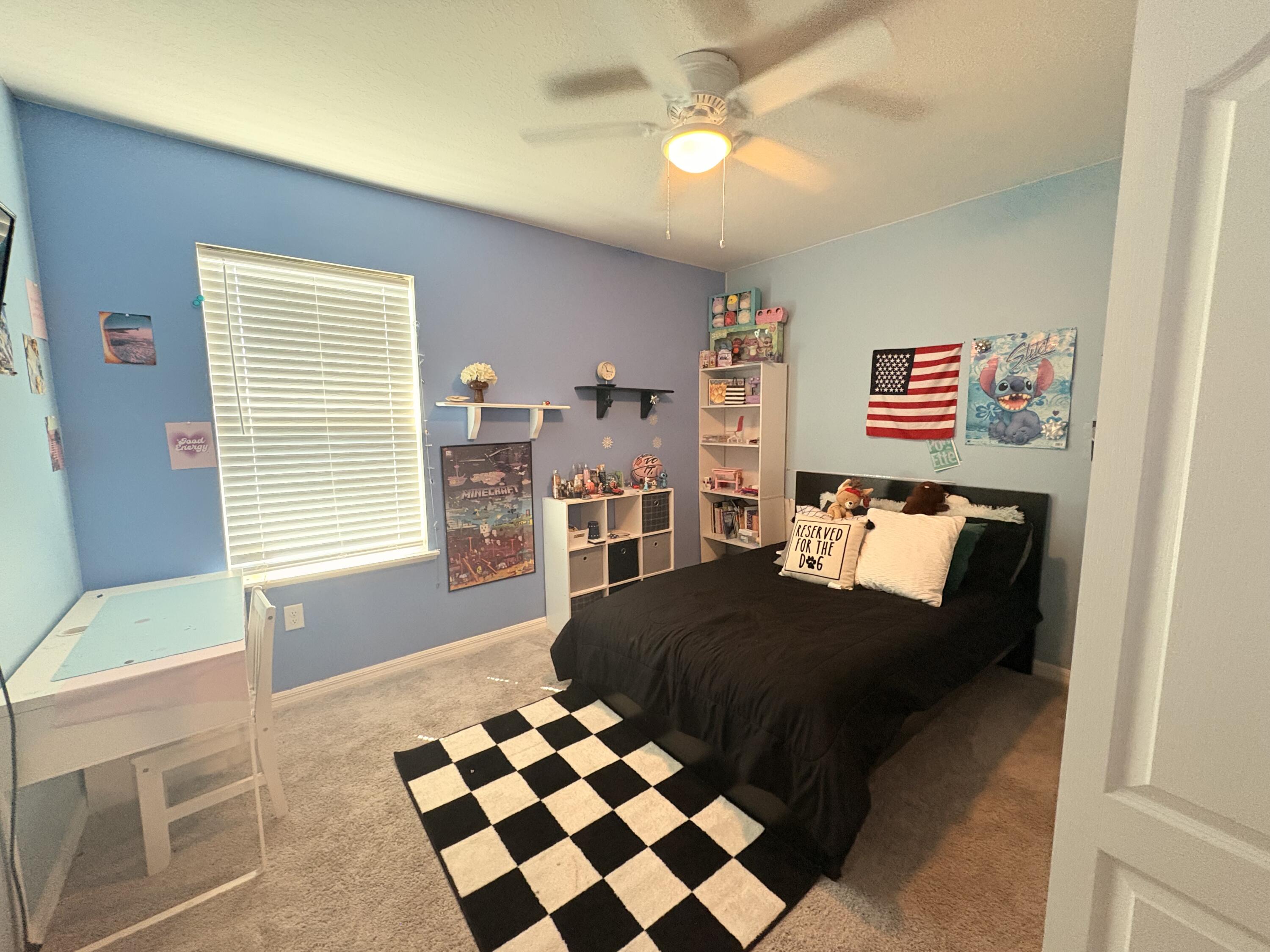 9237 Swiss Road Spring Hill, FL 34606 - Photo 3 of 11 a bedroom with a bed and a chandelier