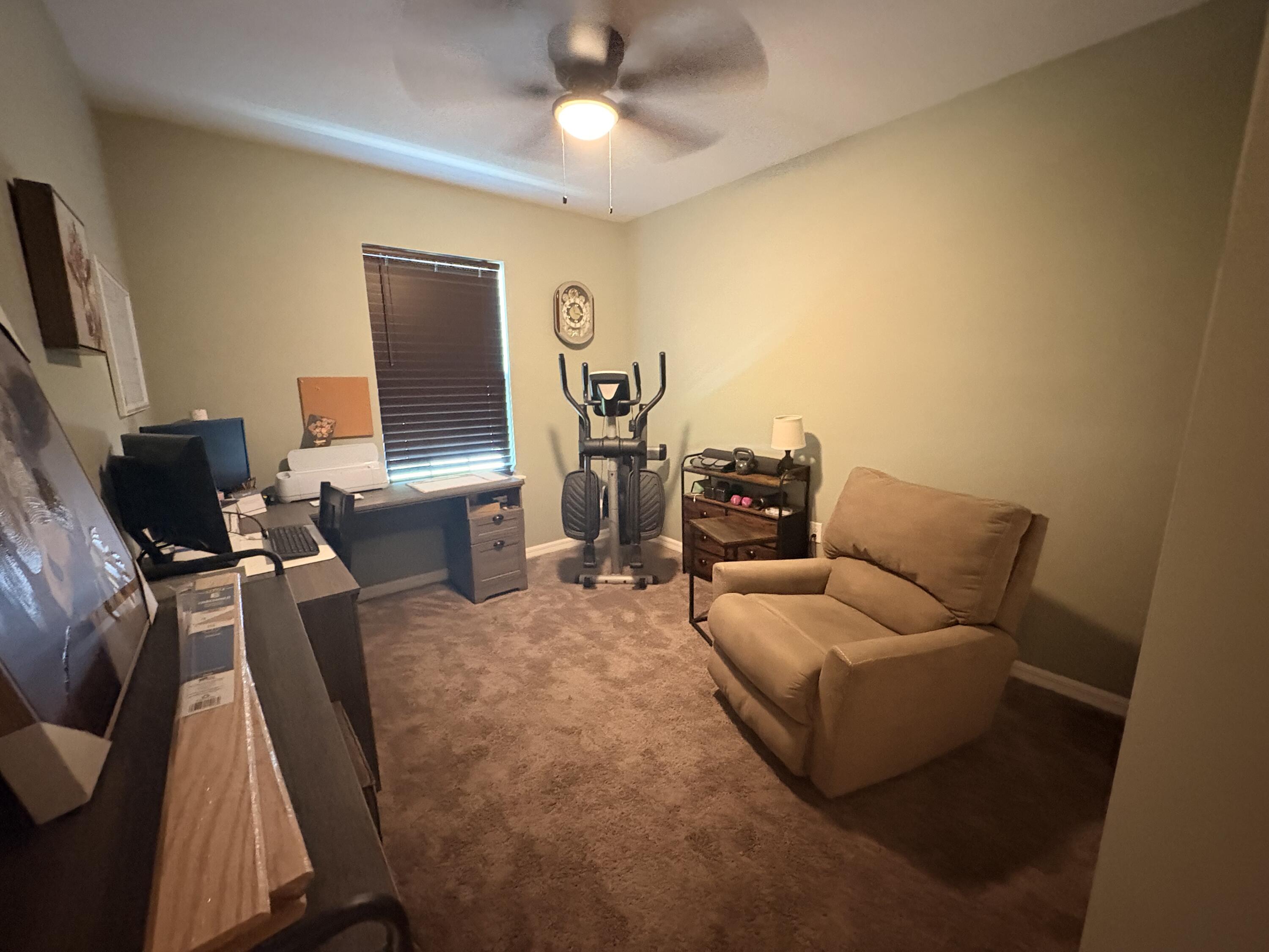 9237 Swiss Road Spring Hill, FL 34606 - Photo 5 of 11 a living room with furniture and a flat screen tv