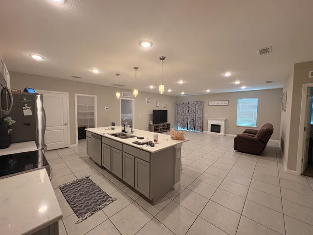 a kitchen with a stove and a refrigerator