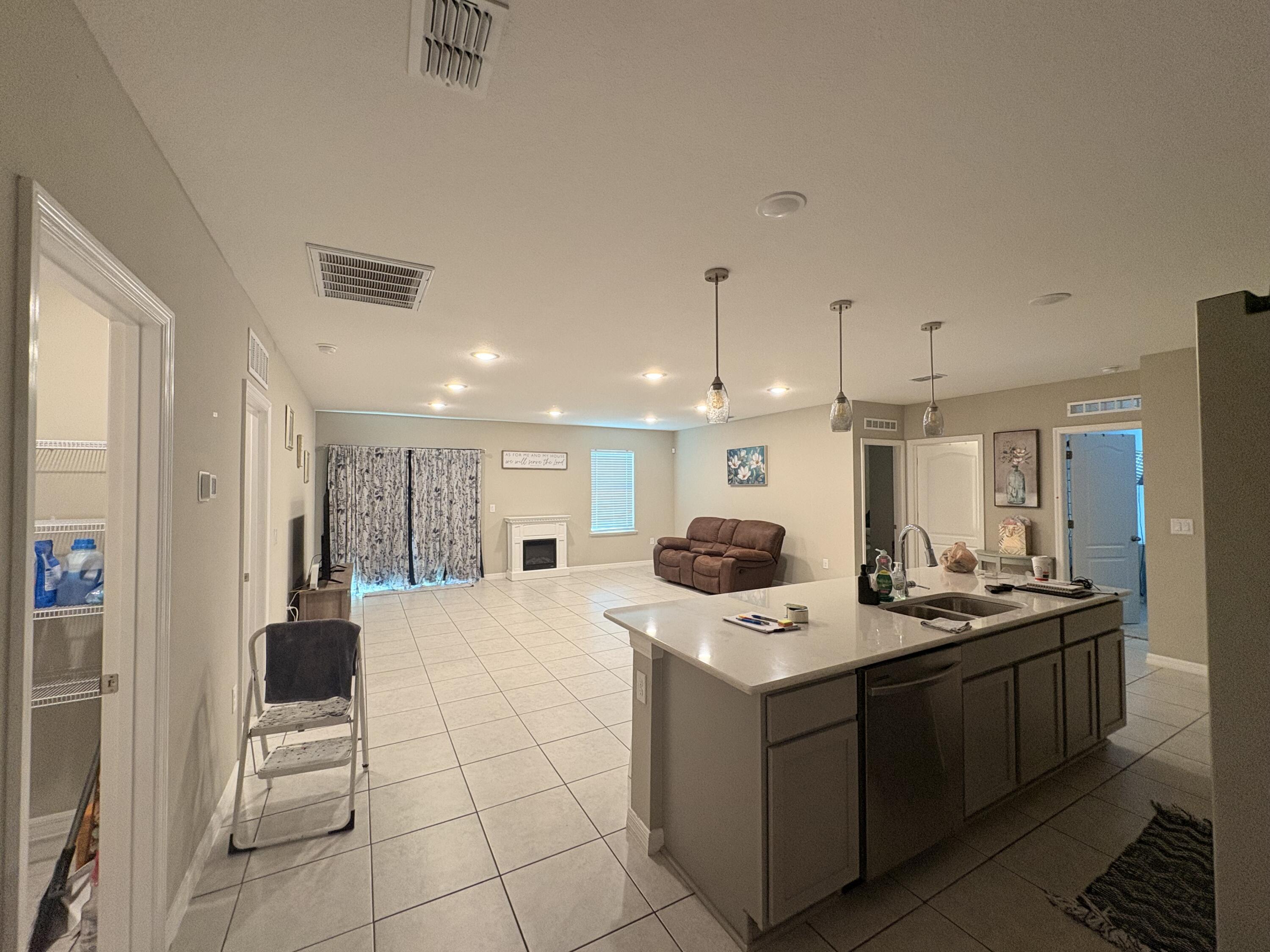 9237 Swiss Road Spring Hill, FL 34606 - Photo 9 of 11 a kitchen with a sink a counter top space stainless steel appliances and cabinets