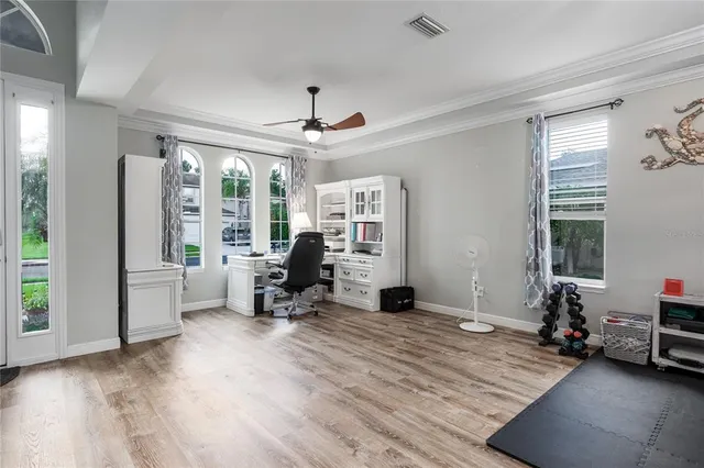 a view of a livingroom with workspace and a window