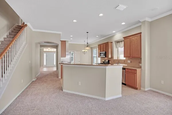 a view of a kitchen with a sink and a refrigerator