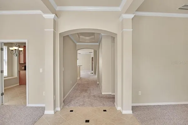 a view of a hallway with wooden floor and closet