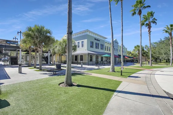 a view of a house with swimming pool and sitting area