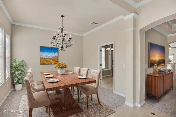 a view of a dining room with furniture and chandelier