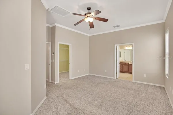 a view of an empty room with a ceiling fan