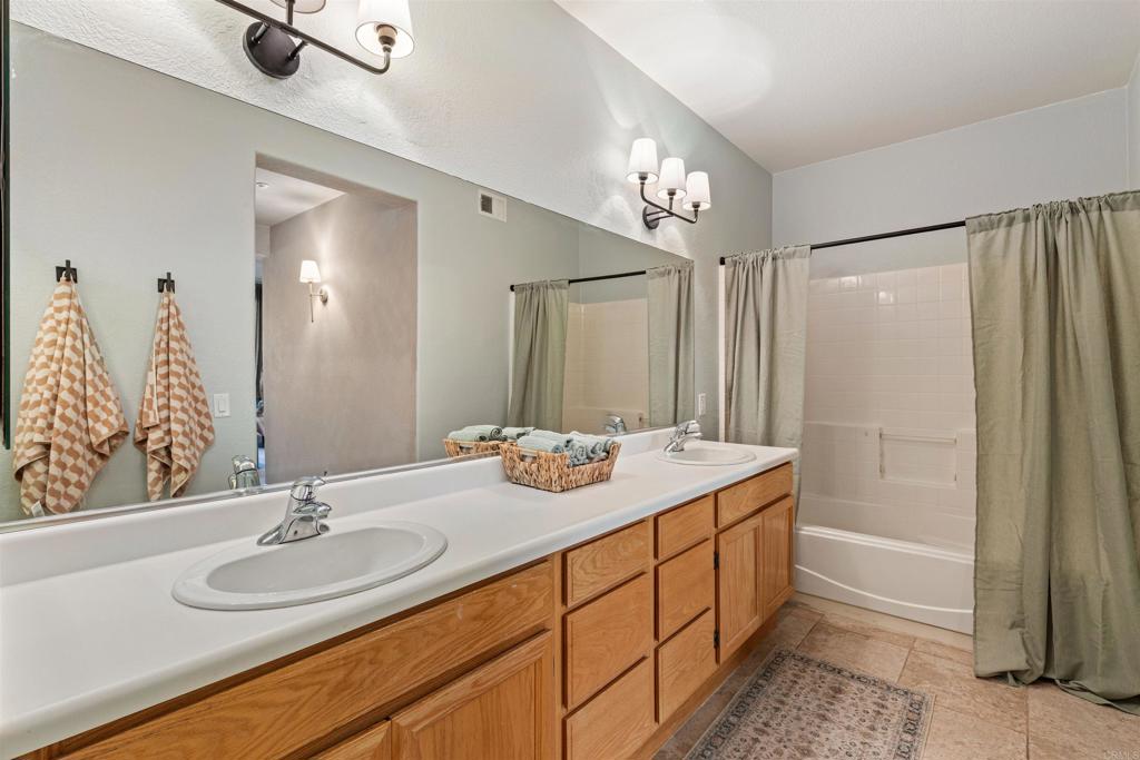 3183 Dehesa Road, Unit 19 El Cajon, CA 92019 - Photo 14 of 26 a bathroom with a sink a double vanity and a mirror