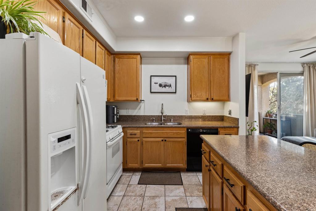 3183 Dehesa Road, Unit 19 El Cajon, CA 92019 - Photo 9 of 26 a kitchen with stainless steel appliances granite countertop a sink stove and refrigerator