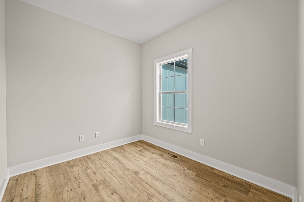 4595 Window Cliff Road Baxter, TN 38544 - Photo 25 of 30 an empty room with wooden floor and windows