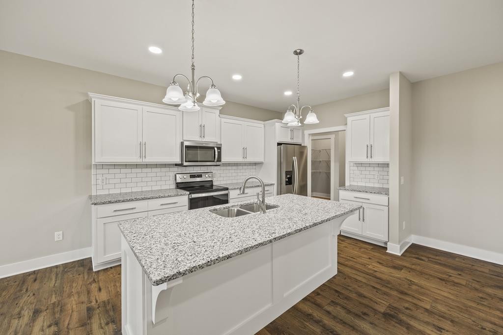 4595 Window Cliff Road Baxter, TN 38544 - Photo 8 of 30 a kitchen with a center island wooden floor and stainless steel appliances