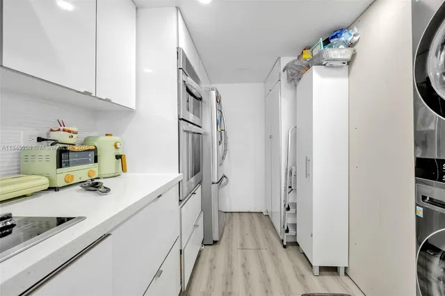 a kitchen with a refrigerator and a sink