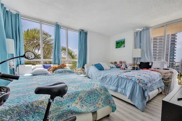 a bedroom with two beds and a large window