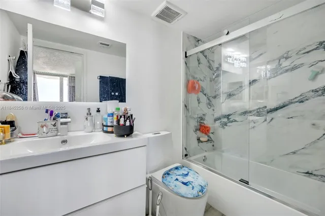 a bathroom with a sink mirror toilet and bathtub