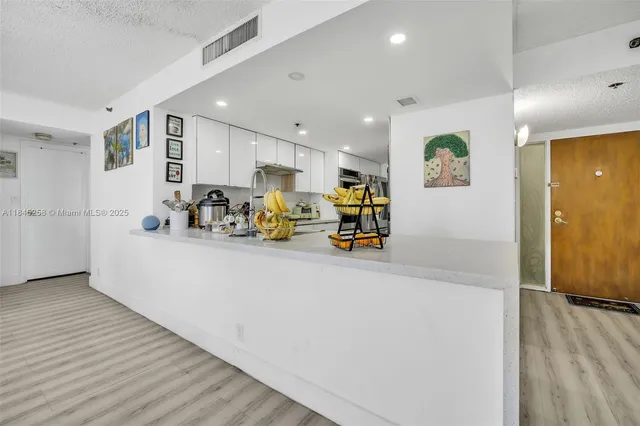 a view of kitchen with stainless steel appliances lots of counter top space