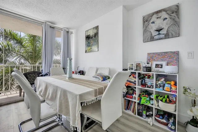 a view of a workspace with furniture and a book shelf