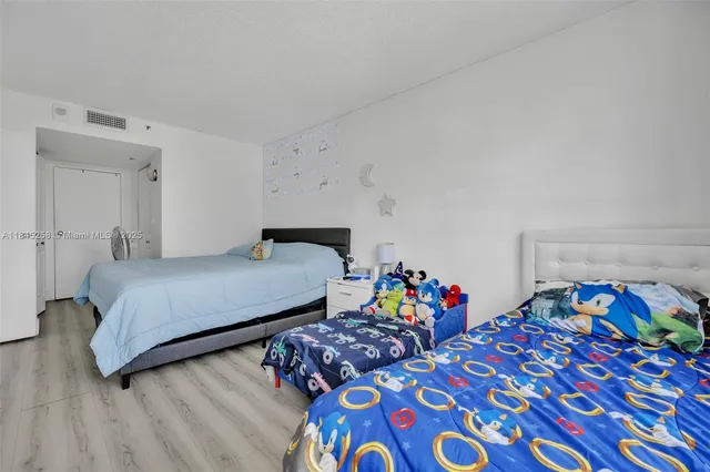 a bedroom with a bed and a dresser in it