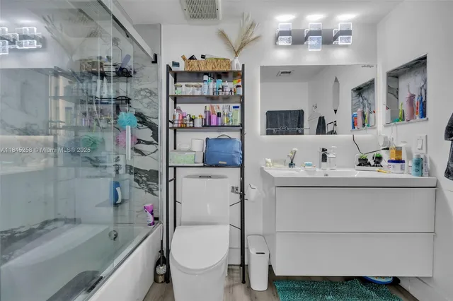 a bathroom with a sink toilet and shower
