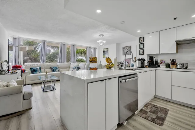 a kitchen with sink refrigerator and cabinets