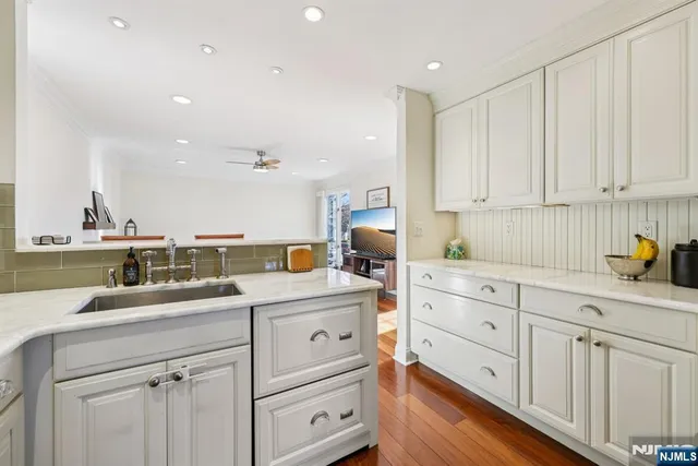 a kitchen with a sink window and cabinets