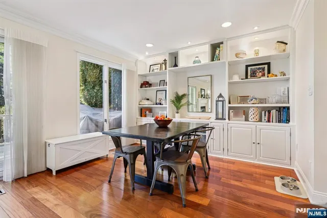 a dining room with furniture and wooden floor