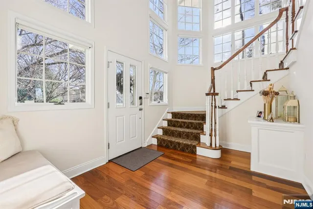 a view of entryway and hall with wooden floor
