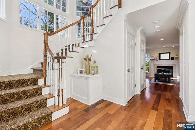 a view of entryway and hall with wooden floor