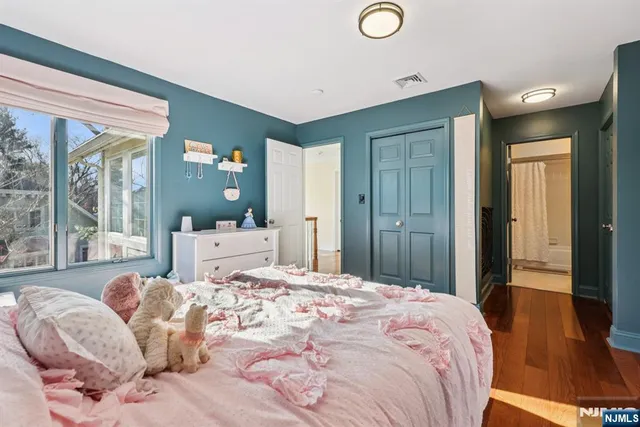 a bedroom with a large bed and a dresser