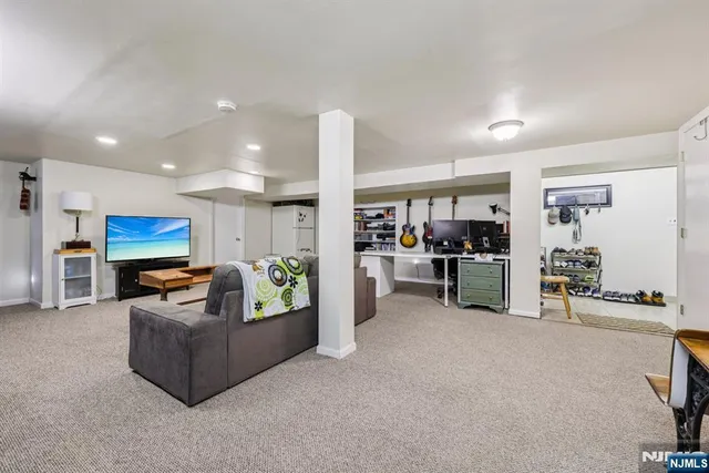 a living room with furniture and kitchen view