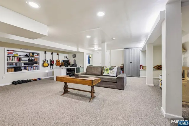 a living room with furniture and a book shelf