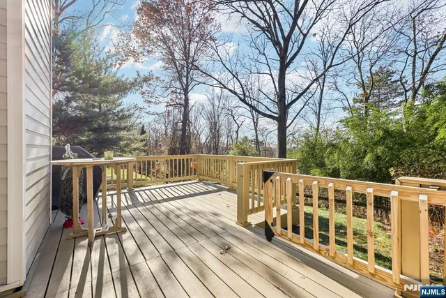 a view of balcony with wooden floor and fence