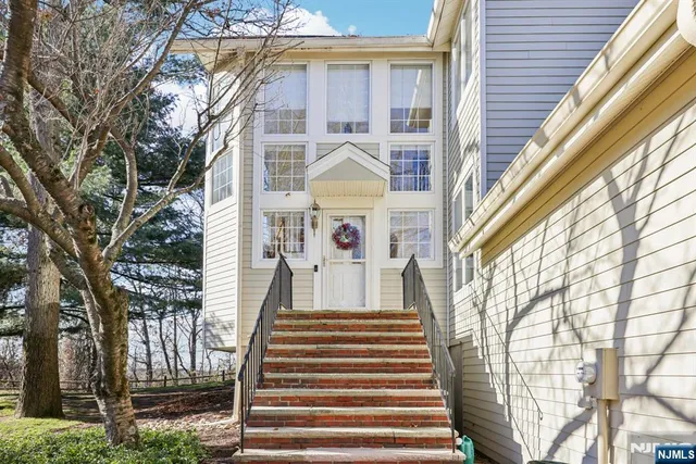 a front view of a house with large windows and ceiling fan