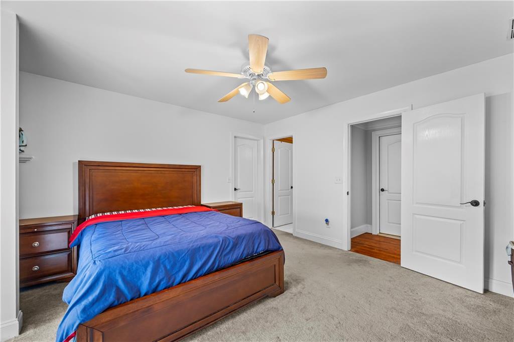 2668 New Hope Road Dacula, GA 30019 - Photo 25 of 65 a bedroom with a bed and a chandelier
