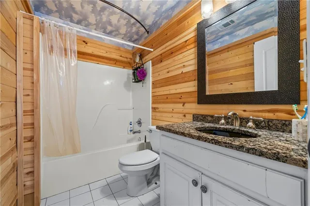 a spacious bedroom with a bed and a window