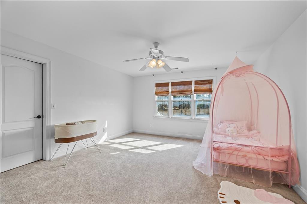 2668 New Hope Road Dacula, GA 30019 - Photo 28 of 65 a spacious bedroom with a bed and a window