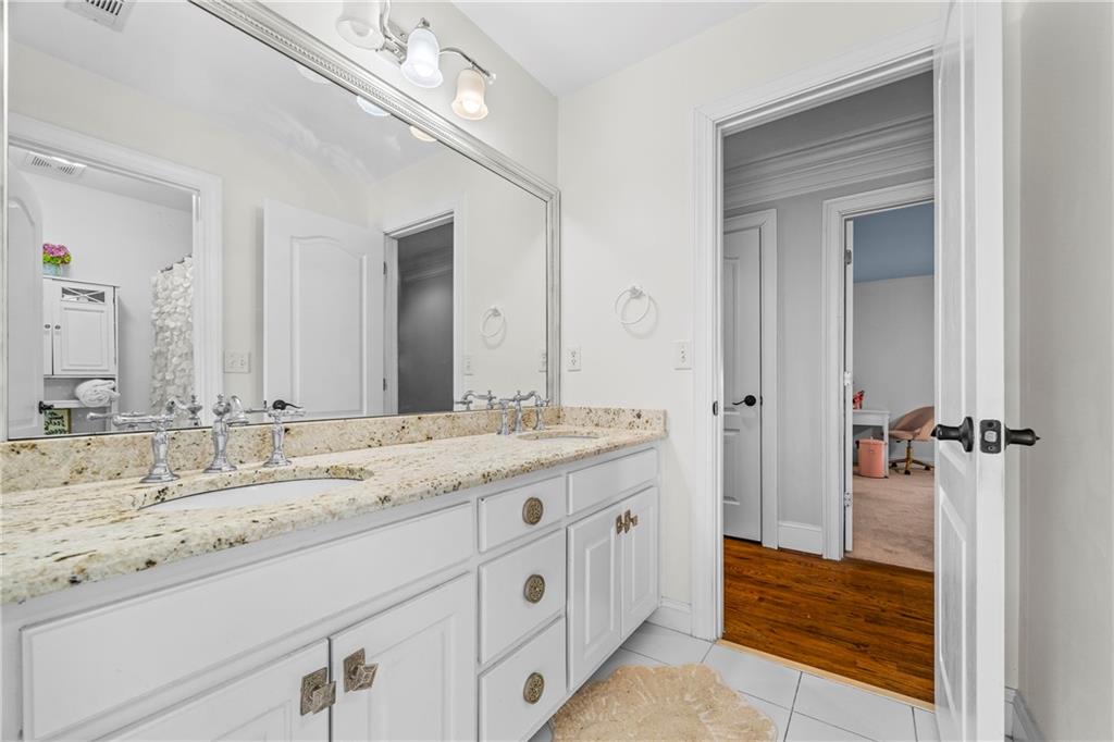 2668 New Hope Road Dacula, GA 30019 - Photo 29 of 65 a bathroom with a granite countertop sink and a mirror