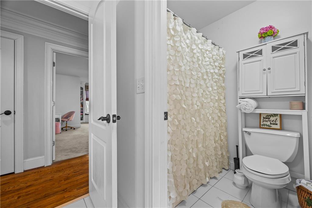 2668 New Hope Road Dacula, GA 30019 - Photo 30 of 65 a bathroom with a toilet and a shower